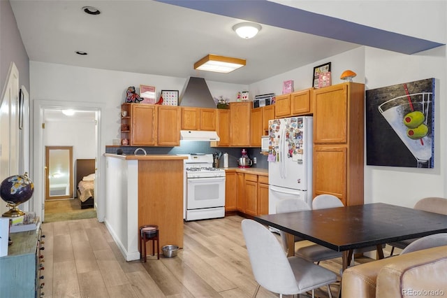2087 S Grant St, Denver, CO 80210 - kitchen with light wood-type flooring, white appliances, open shelves, under cabinet range hood, and brown cabinets