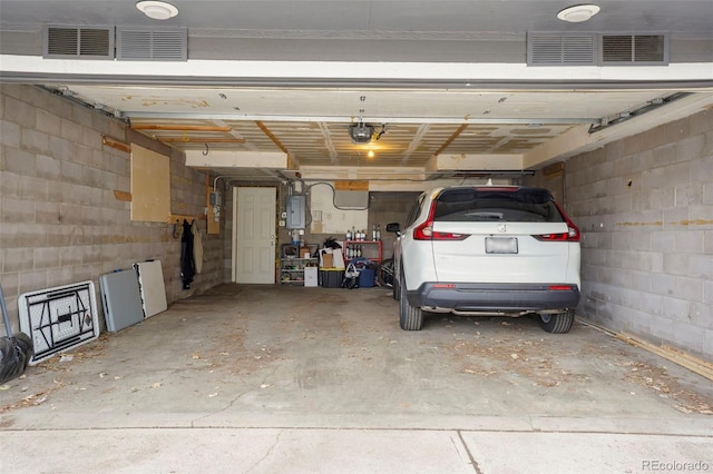 2087 S Grant St, Denver, CO 80210 - garage with visible vents, concrete block wall, a garage door opener, and electric panel