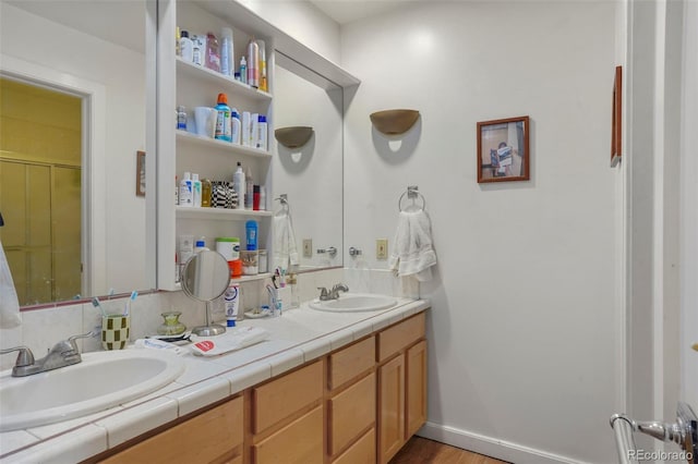 2087 S Grant St, Denver, CO 80210 - bathroom with wood finished floors, double vanity, and a sink