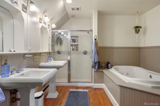 2087 S Grant St, Denver, CO 80210 - full bathroom with a shower stall, a tub with jets, a wainscoted wall, and wood finished floors