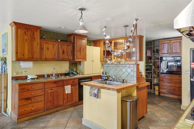 2087 S Grant St, Denver, CO 80210 - kitchen with a sink, black appliances, decorative light fixtures, and an island with sink