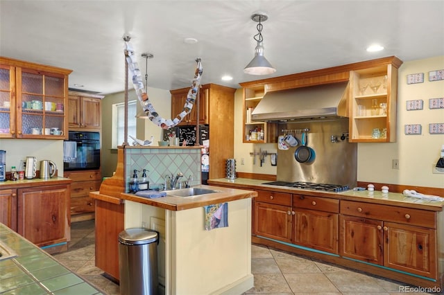 2087 S Grant St, Denver, CO 80210 - kitchen featuring open shelves, a sink, wall chimney range hood, stainless steel gas stovetop, and black oven