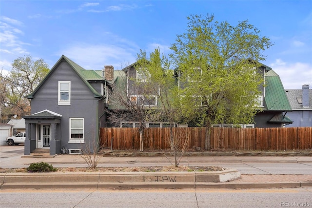 2087 S Grant St, Denver, CO 80210 - view of property exterior featuring fence, stucco siding, and a chimney