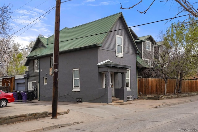 2087 S Grant St, Denver, CO 80210 - view of front of property featuring metal roof, stucco siding, and fence