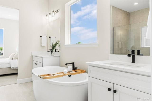 5970 S Platte Canyon Dr, Littleton, CO 80123 - full bathroom with two vanities, a freestanding bath, tiled shower, ensuite bathroom, and recessed lighting