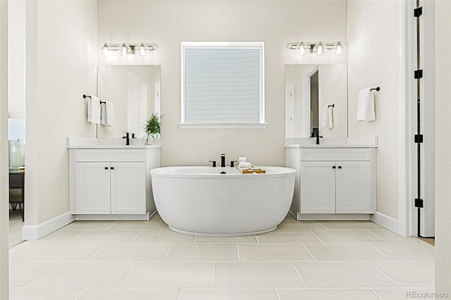 5970 S Platte Canyon Dr, Littleton, CO 80123 - full bath with a freestanding tub, two vanities, tile patterned flooring, and baseboards