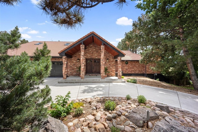 12570 W 60th Ave, Arvada, CO 80004 - view of front of house featuring a tiled roof and brick siding