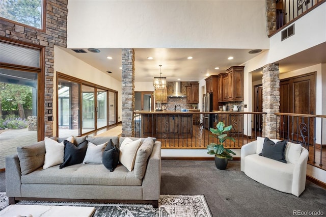 12570 W 60th Ave, Arvada, CO 80004 - living area with a high ceiling, decorative columns, recessed lighting, and a chandelier