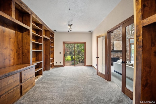 12570 W 60th Ave, Arvada, CO 80004 - unfurnished living room with carpet floors, french doors, a textured ceiling, and baseboards