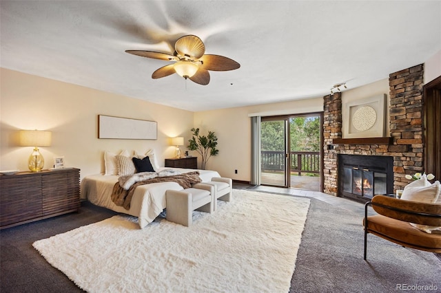 12570 W 60th Ave, Arvada, CO 80004 - bedroom with access to exterior, a stone fireplace, carpet, and a ceiling fan