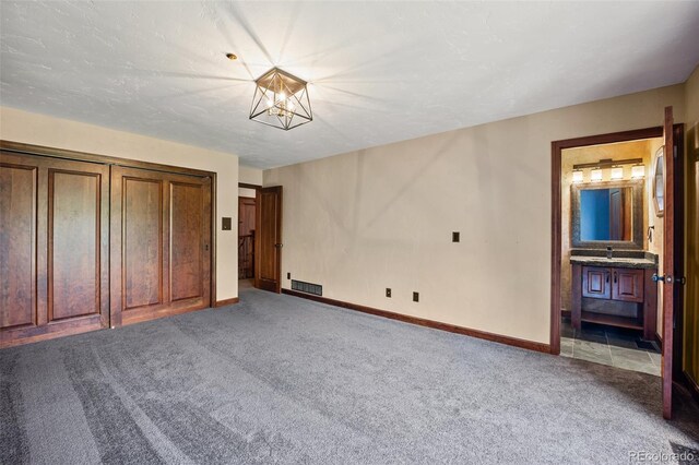12570 W 60th Ave, Arvada, CO 80004 - unfurnished bedroom with carpet floors, baseboards, a chandelier, and connected bathroom