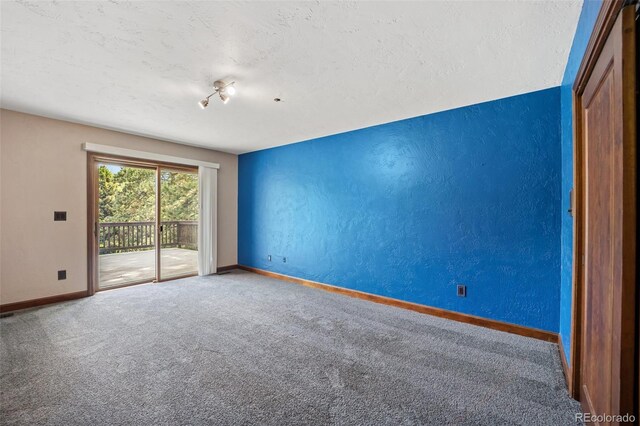 12570 W 60th Ave, Arvada, CO 80004 - carpeted empty room with baseboards, a textured ceiling, and a textured wall