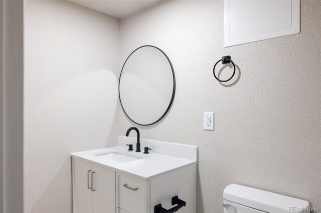 bathroom featuring vanity and toilet