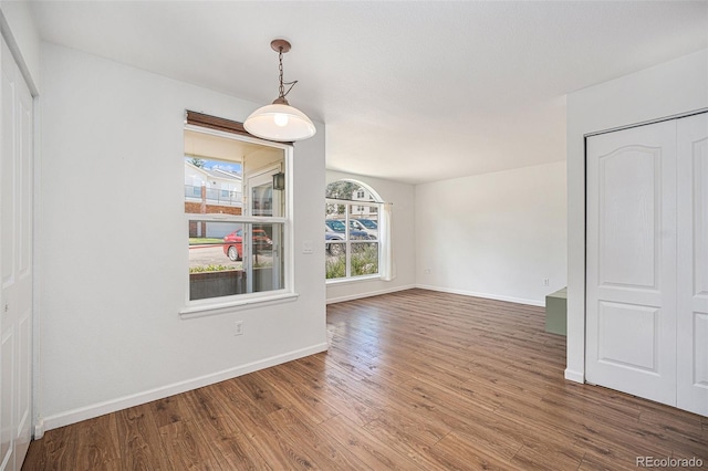 unfurnished dining area featuring hardwood / wood-style floors