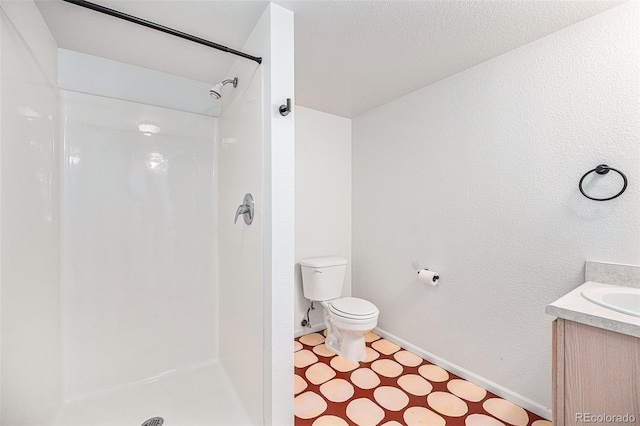 bathroom featuring vanity, toilet, and walk in shower