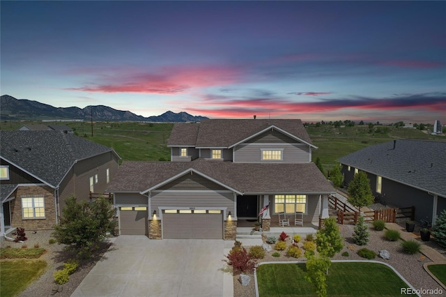 8803 Antero Ct, Arvada, CO 80007 - traditional-style home featuring a garage, a porch, driveway, a mountain view, and roof with shingles
