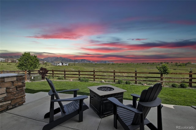 8803 Antero Ct, Arvada, CO 80007 - patio terrace at dusk featuring an outdoor fire pit, a patio area, and a rural view