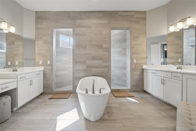 8803 Antero Ct, Arvada, CO 80007 - full bath featuring tile walls, two vanities, a freestanding bath, and a walk in shower