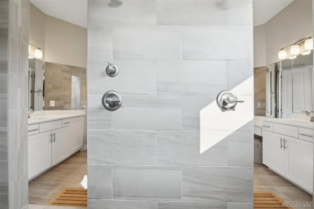 8803 Antero Ct, Arvada, CO 80007 - bathroom featuring a tile shower and two vanities