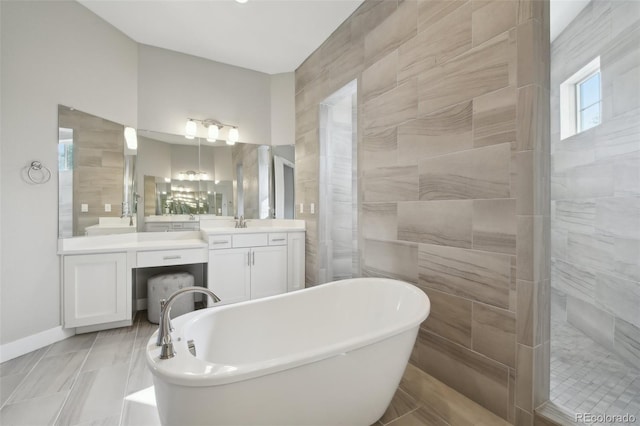 8803 Antero Ct, Arvada, CO 80007 - bathroom with a freestanding tub, vanity, a walk in shower, and baseboards