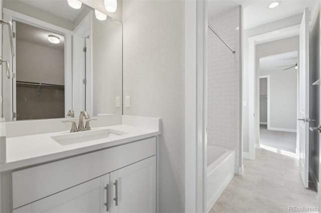 8803 Antero Ct, Arvada, CO 80007 - full bathroom featuring vanity, tub / shower combination, a spacious closet, tile patterned flooring, and recessed lighting