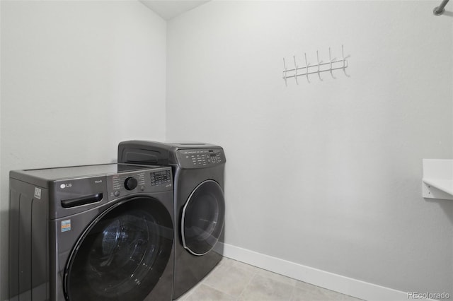 8803 Antero Ct, Arvada, CO 80007 - washroom featuring washing machine and dryer, baseboards, and tile patterned floors