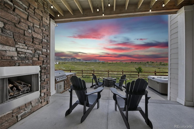 8803 Antero Ct, Arvada, CO 80007 - view of patio featuring an outdoor fire pit, exterior fireplace, and a view of rural / pastoral area