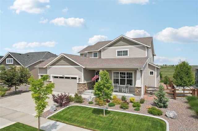 8803 Antero Ct, Arvada, CO 80007 - craftsman house with a porch, roof with shingles, stone siding, concrete driveway, and a garage