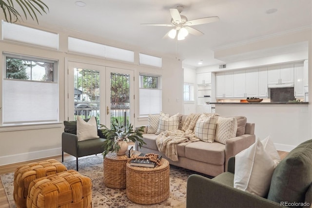 300 Hudson St Unit 109, Denver, CO 80220 - living area with ceiling fan, baseboards, wood finished floors, and crown molding