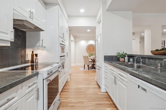 300 Hudson St Unit 109, Denver, CO 80220 - kitchen with white appliances, a sink, under cabinet range hood, white cabinetry, and crown molding