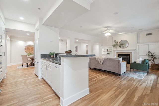 300 Hudson St Unit 109, Denver, CO 80220 - kitchen with white appliances, dark countertops, a ceiling fan, white cabinetry, and light wood-style flooring
