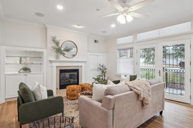 300 Hudson St Unit 109, Denver, CO 80220 - living room with crown molding, ceiling fan, a fireplace, light wood-type flooring, and recessed lighting