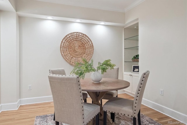 300 Hudson St Unit 109, Denver, CO 80220 - dining room featuring light wood-style flooring, ornamental molding, and baseboards