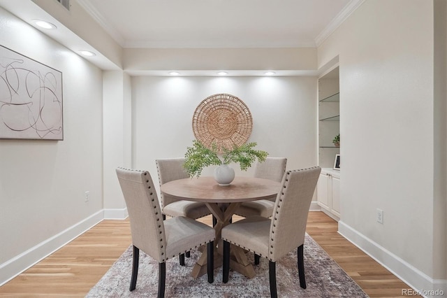 300 Hudson St Unit 109, Denver, CO 80220 - dining space featuring crown molding, light wood-style flooring, baseboards, built in shelves, and recessed lighting