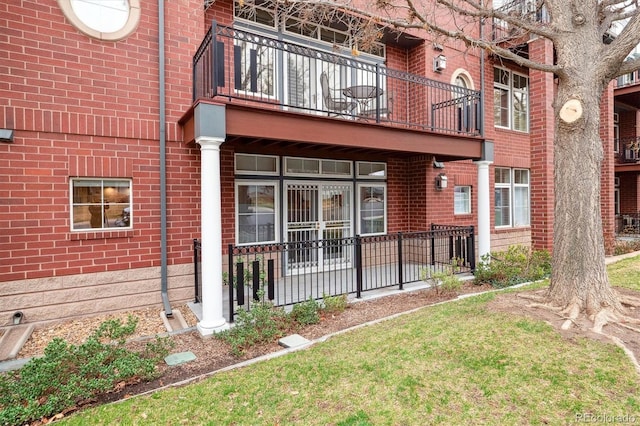 300 Hudson St Unit 109, Denver, CO 80220 - back of house with a balcony and brick siding