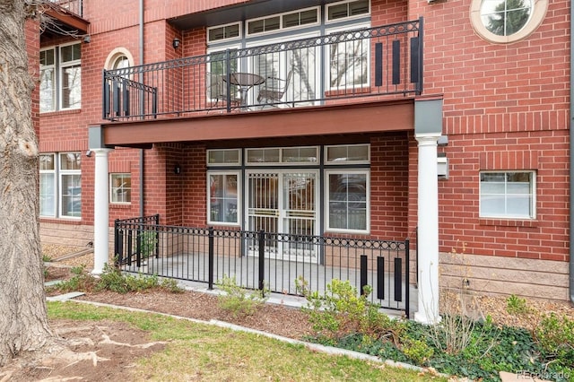 300 Hudson St Unit 109, Denver, CO 80220 - entrance to property featuring a balcony and brick siding