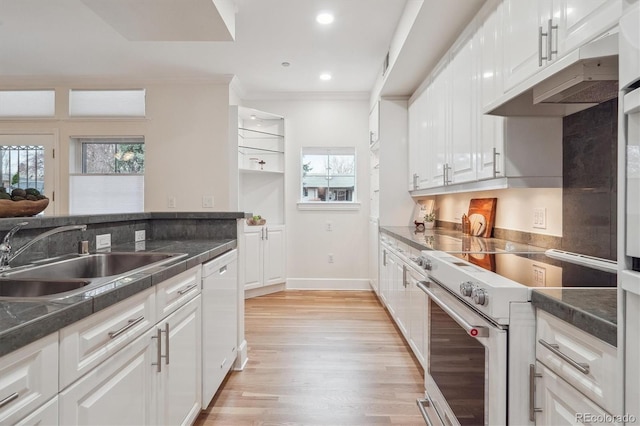 300 Hudson St Unit 109, Denver, CO 80220 - kitchen with white appliances, a sink, light wood-style flooring, dark countertops, and crown molding
