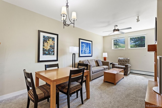 dining space featuring baseboard heating, light colored carpet, and ceiling fan with notable chandelier