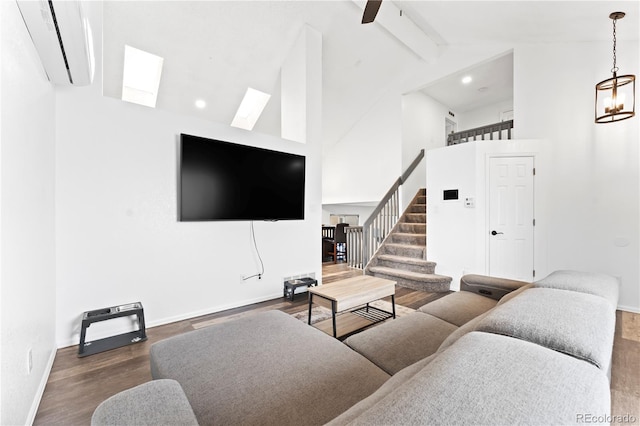 12119 Forest St, Thornton, CO 80241 - living area with a wall mounted AC, beam ceiling, stairway, high vaulted ceiling, and baseboards