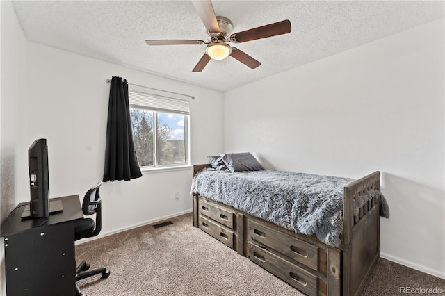 12119 Forest St, Thornton, CO 80241 - carpeted bedroom featuring a textured ceiling, ceiling fan, and baseboards