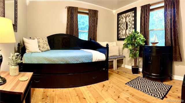 bedroom with hardwood / wood-style flooring and baseboards