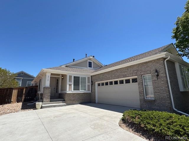 20148 E Dartmouth Dr, Aurora, CO 80013 - single story home featuring an attached garage, brick siding, and driveway