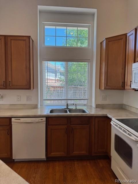 20148 E Dartmouth Dr, Aurora, CO 80013 - kitchen with white appliances, a sink, and brown cabinets
