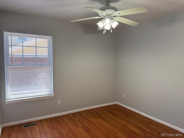 20148 E Dartmouth Dr, Aurora, CO 80013 - unfurnished room featuring wood finished floors, baseboards, and ceiling fan