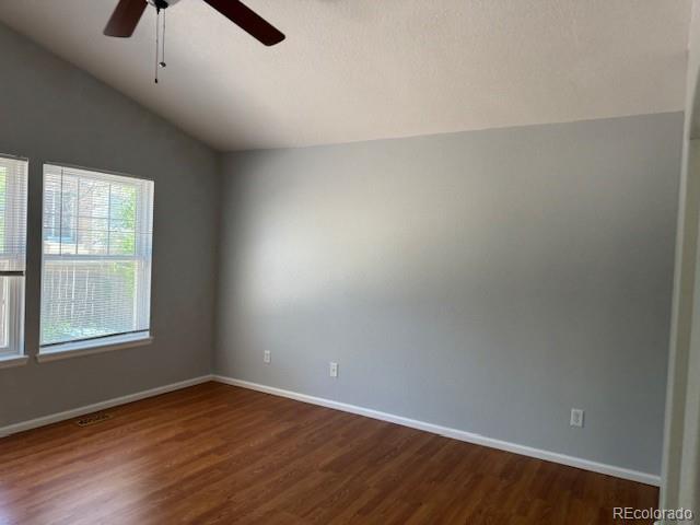 20148 E Dartmouth Dr, Aurora, CO 80013 - empty room featuring lofted ceiling, dark wood-style floors, a ceiling fan, and baseboards