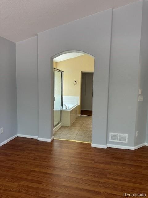 20148 E Dartmouth Dr, Aurora, CO 80013 - spare room with arched walkways, wood finished floors, and baseboards