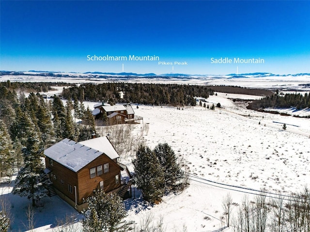 snowy aerial view with a mountain view