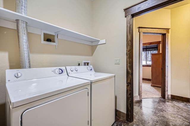 clothes washing area with washing machine and dryer