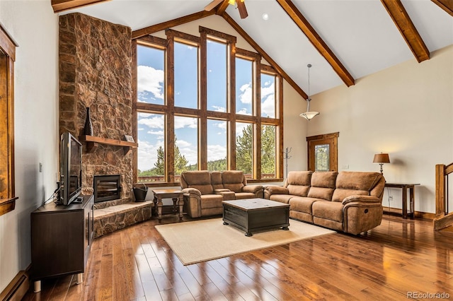 1424 Bluestem Way, Fairplay, CO 80440 - living area featuring high vaulted ceiling, a baseboard heating unit, wood-type flooring, beam ceiling, and a fireplace