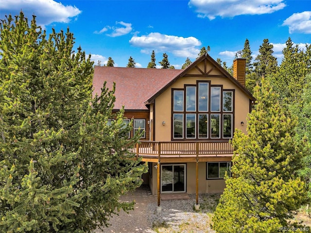 1424 Bluestem Way, Fairplay, CO 80440 - rear view of house featuring a chimney, a wooden deck, and stucco siding